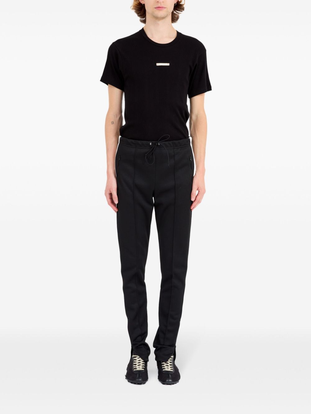 Pantalon Maison Margiela noir avec détails à rayures