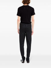 Pantalon Maison Margiela noir avec détails à rayures