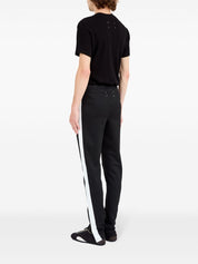 Pantalon Maison Margiela noir avec détails à rayures