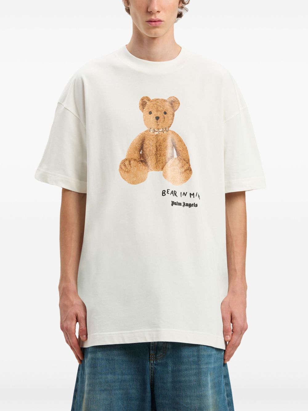 Alt Tag: Palm Angels white T-shirt with teddy bear print, casual style.