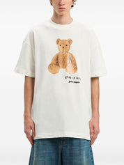 Alt Tag: Palm Angels white T-shirt with teddy bear print, casual style.